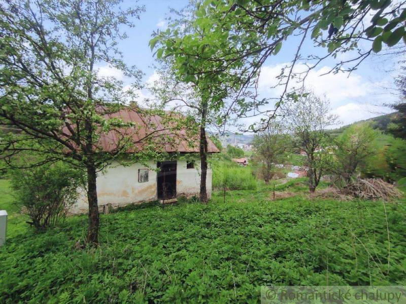 A country house surrounded by greenery and trees, set in a picturesque landscape.