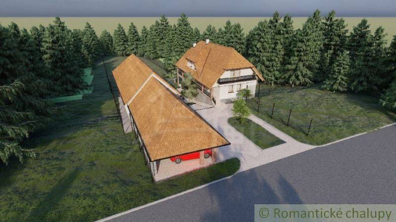 A traditional family house near the forest with a spacious yard and a farm building.