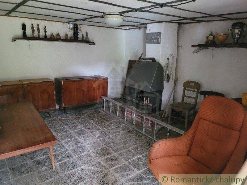 A room in a family house with antique furniture and decorations on the shelves.