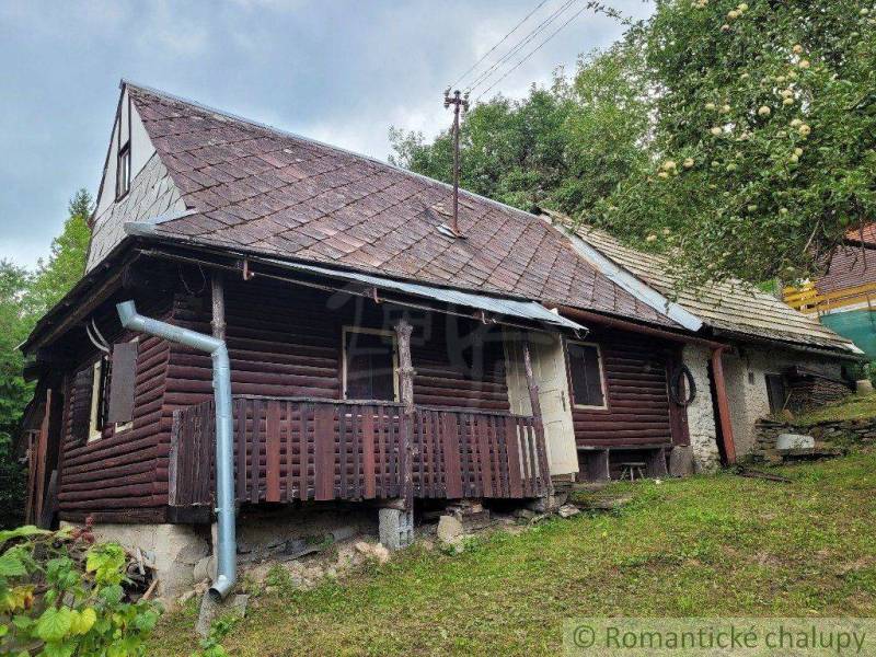 Old wooden cottage, suitable as a family house, surrounded by trees with a garden.