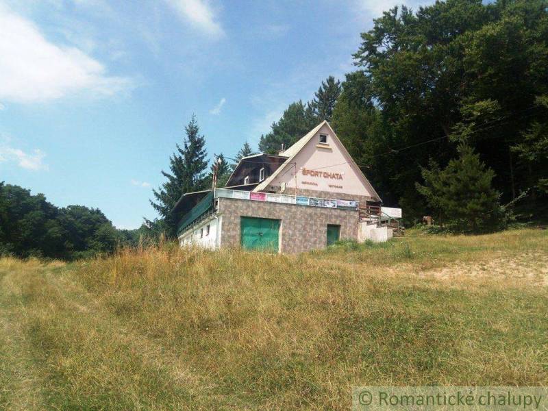A cottage in nature surrounded by grass and forest, ideal for relaxation and hiking.