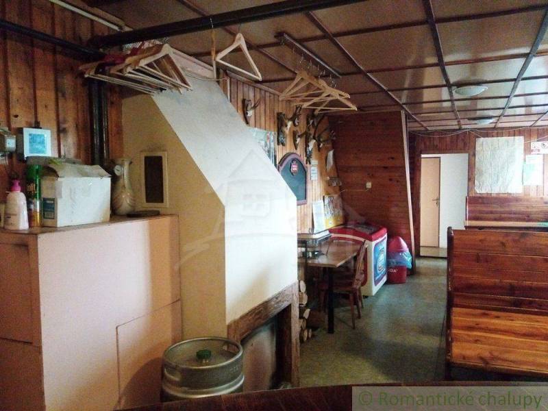 The interior of a wooden cabin with seating, coat hooks, and decorations creates a pleasant atmosphere.
