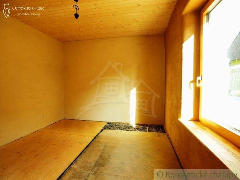 A room with a wooden ceiling and floor, light from the window, natural materials, family house.