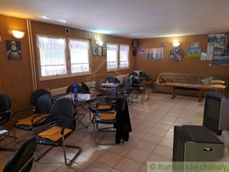 Interior of a café in commercial premises with comfortable armchairs, tables, and decorations.