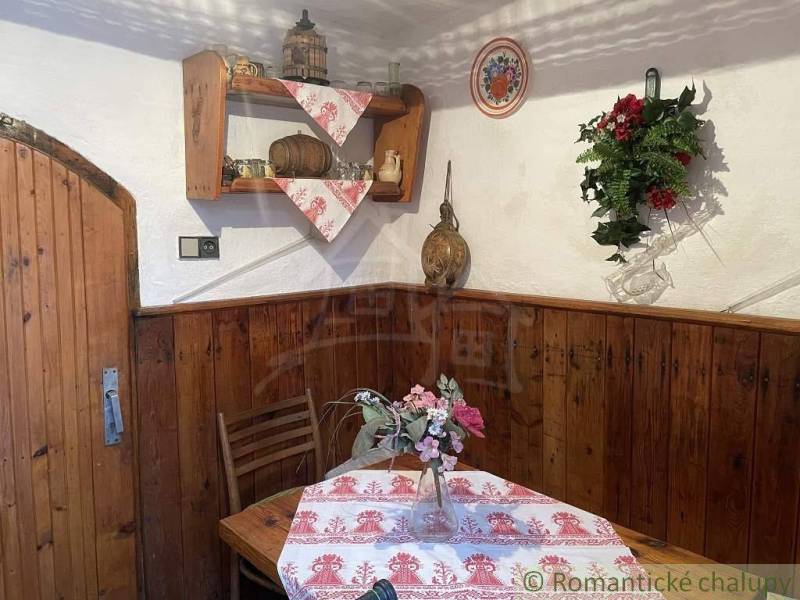 A wooden interior with traditional decorations and flowers in a cottage creates a cozy atmosphere.