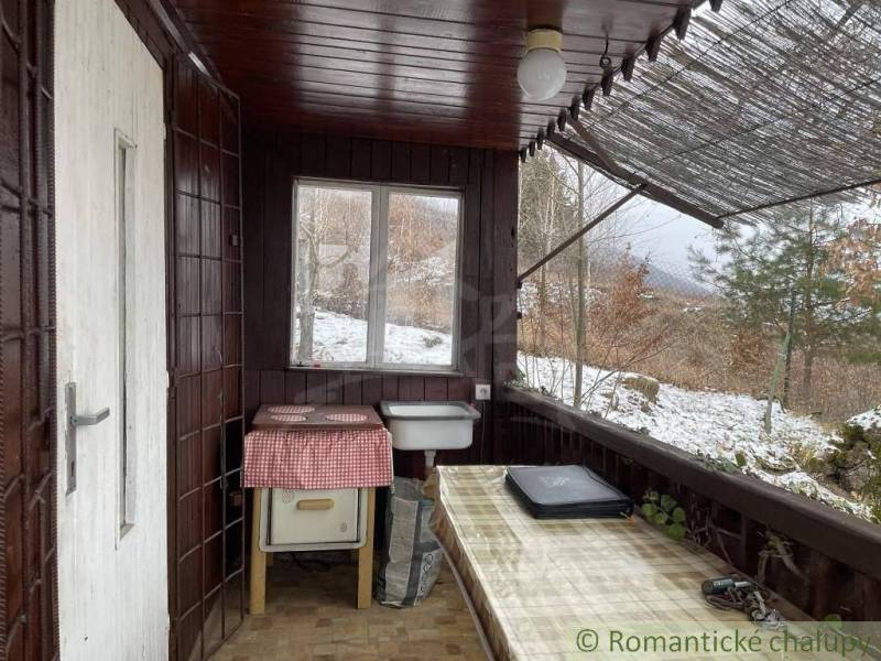 A covered porch with a view of the snowy landscape, a great place for rest and relaxation.