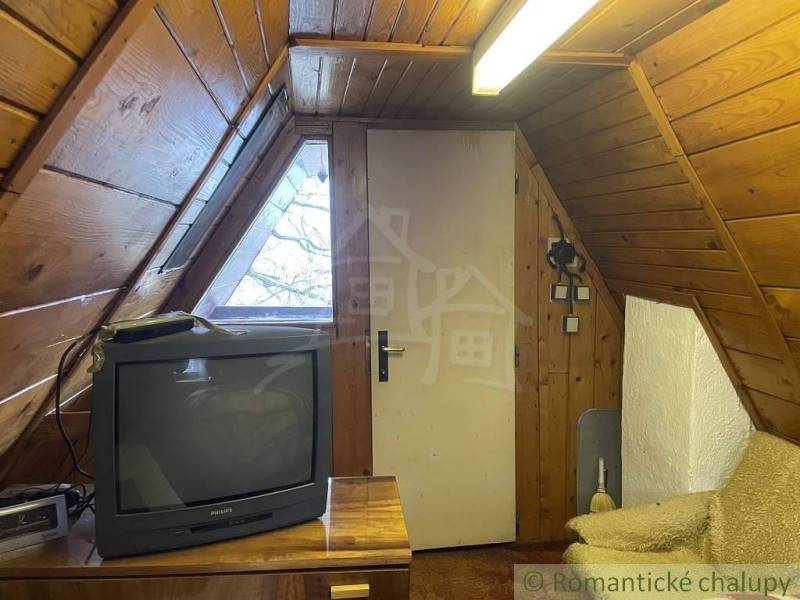 Attic wooden room, retro television, sofa set, **cottage** for a recreational stay.