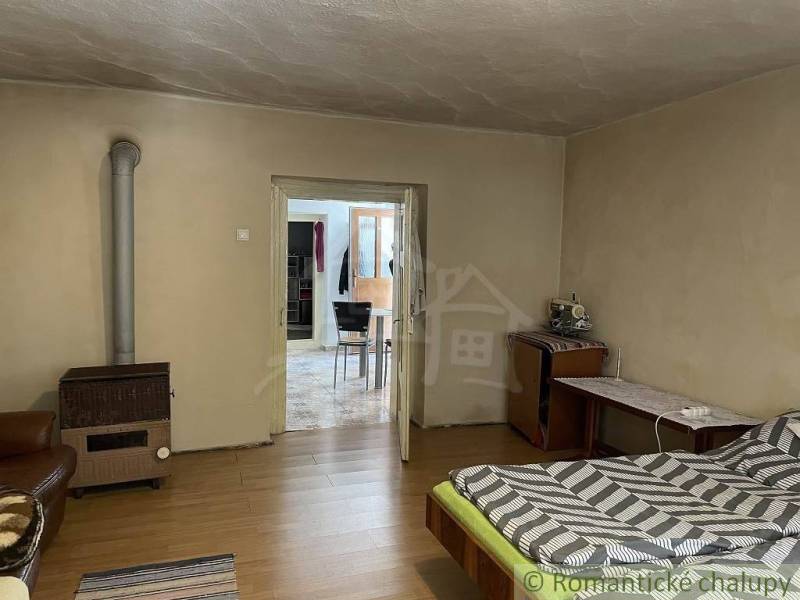 Room, bed, carpet, stove, antique furniture, family house.