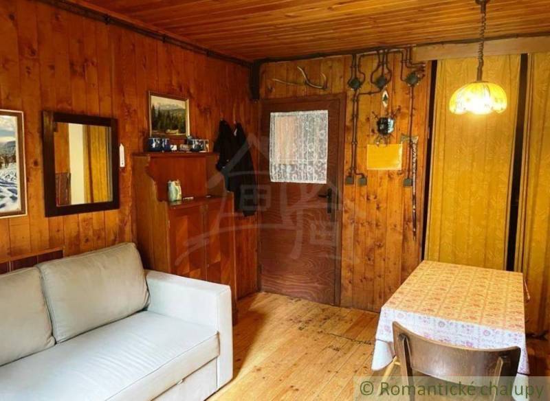 Wooden interiors with a sofa and dining table, cozy atmosphere, cabin for relaxation.