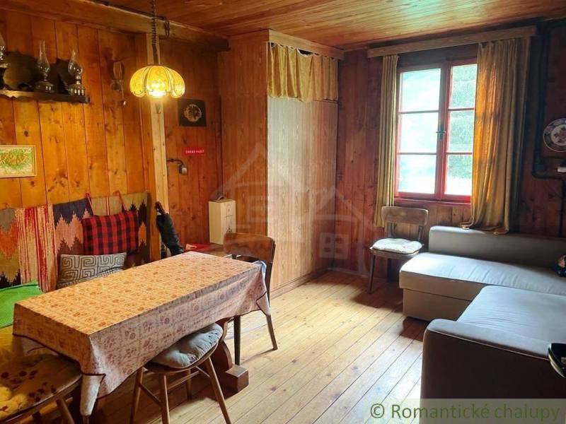 Wooden interior with cozy seating and decorative lamps in a mountain cabin.