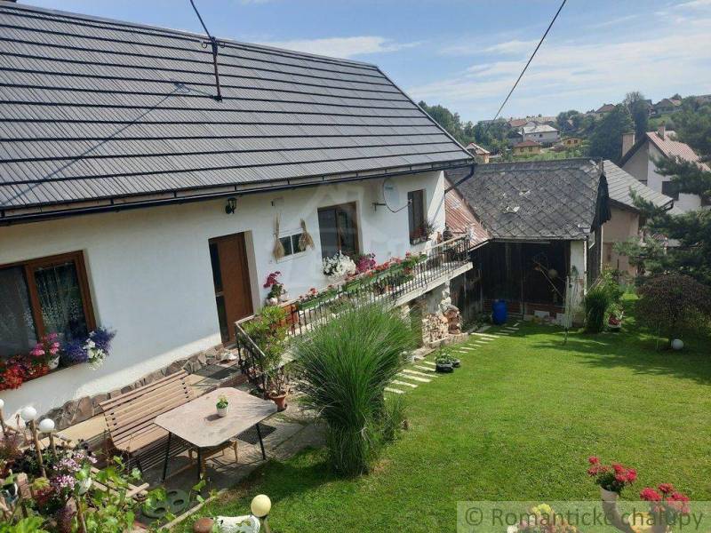 A family house with flowers and a green garden, an ideal place for relaxation.
