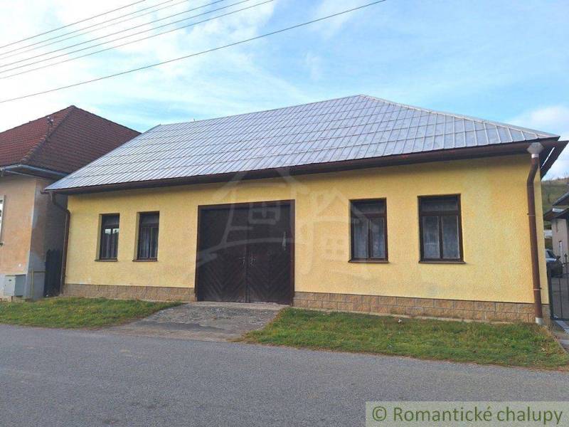 A yellow building with a metal roof, suitable for commercial spaces in a village environment.
