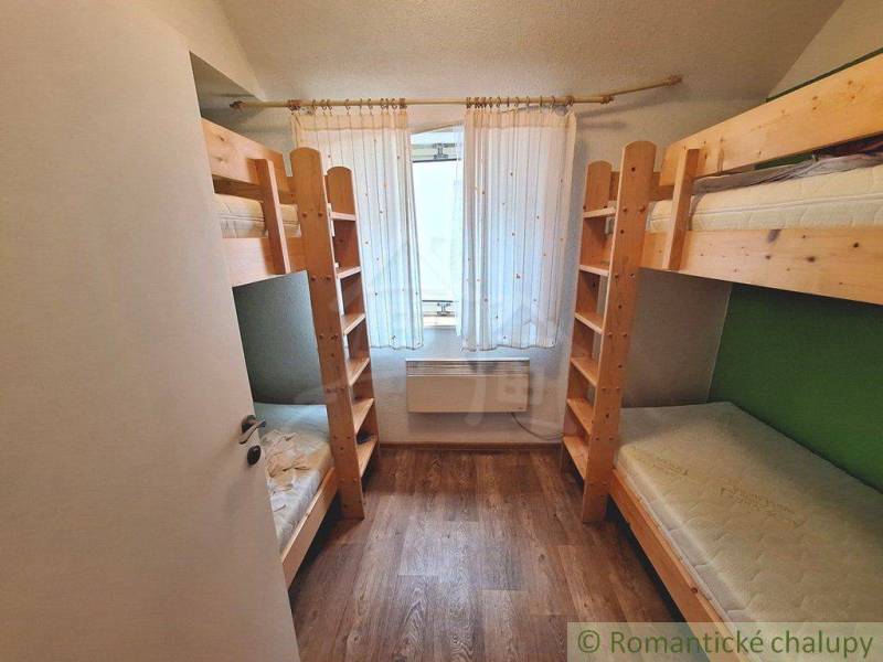 Bunk beds made of light wood in a small room, accessories for commercial spaces.