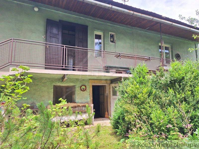 A two-story house with a terrace, surrounded by lush greenery, ideal for living. The plots offer tranquility.