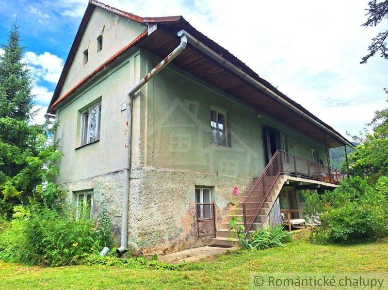 A family house with a veranda, staircase, and garden. An ideal place for peaceful living.