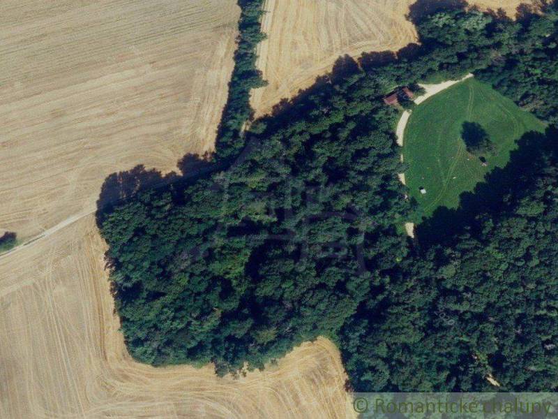 Aerial view of a forest and meadow, ideal for recreational properties.