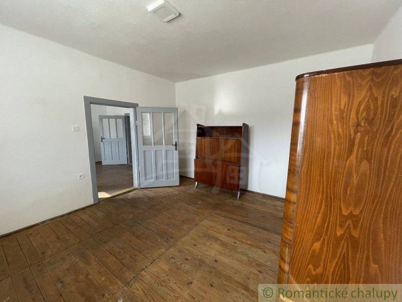 A room with wooden floors and antique furniture in a family house.
