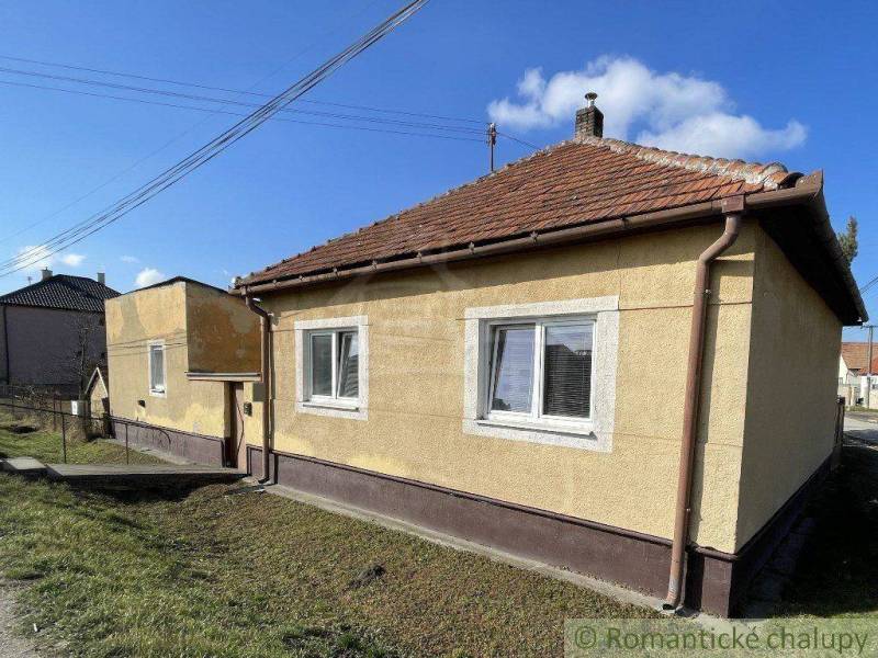 A family house with a brick gable roof in a peaceful village location.