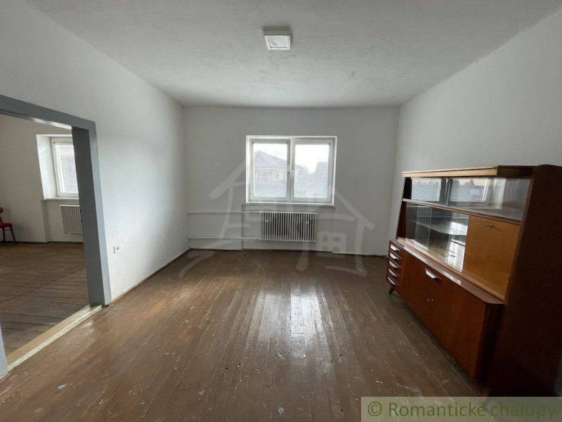 A room in a family house with older furniture and well-preserved wooden floors.