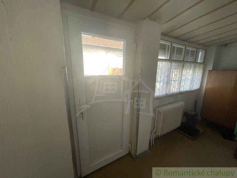 Doors and windows in the interior of a family house, radiator, cabinet.