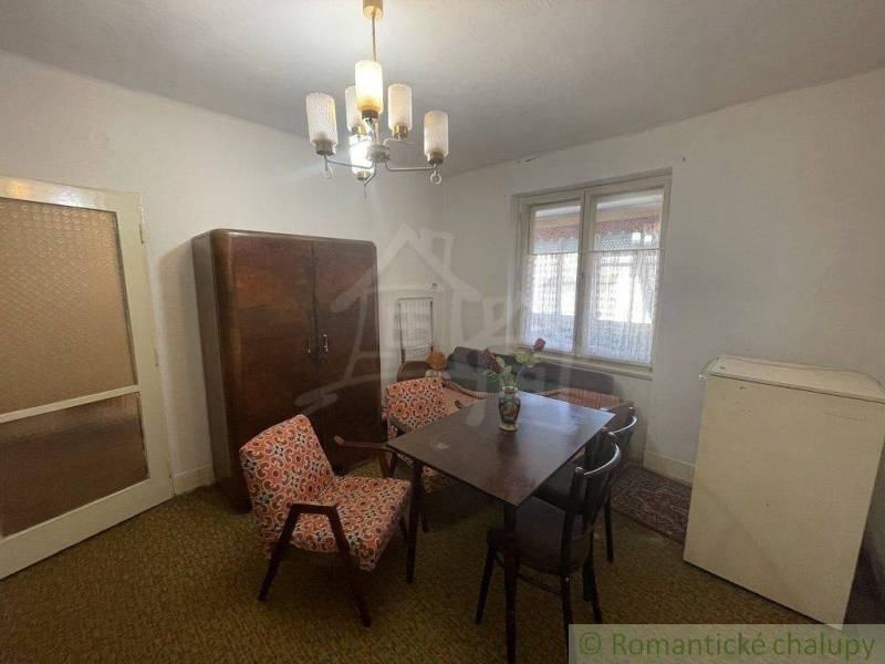Interior of a family house with furniture, table, chairs, wardrobe, and lighting.