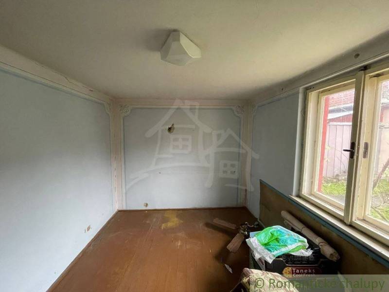 Room in a family house, simple decoration, window with a view of the garden.