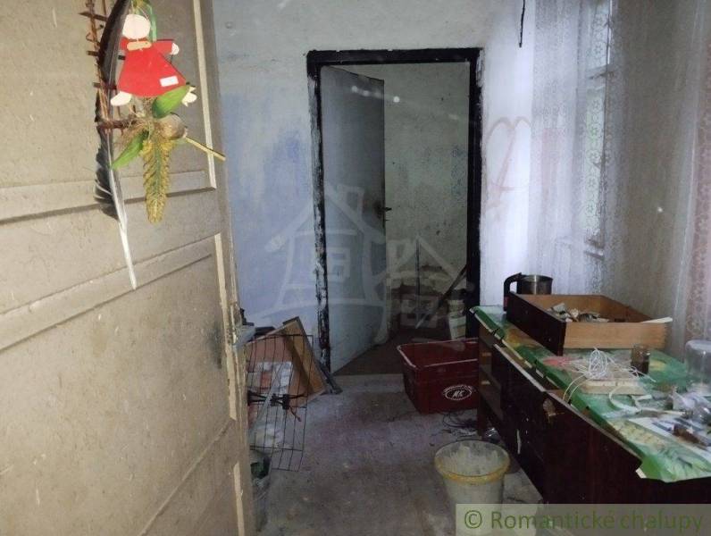 Family house, hallway with decoration and old furniture, needs renovation and maintenance.