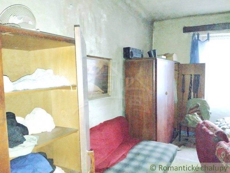 Interior of the room: old furniture, bed, armchair, living room in a family house in the village.