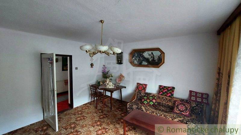 A living room in a family house with vintage furniture and traditional decor.