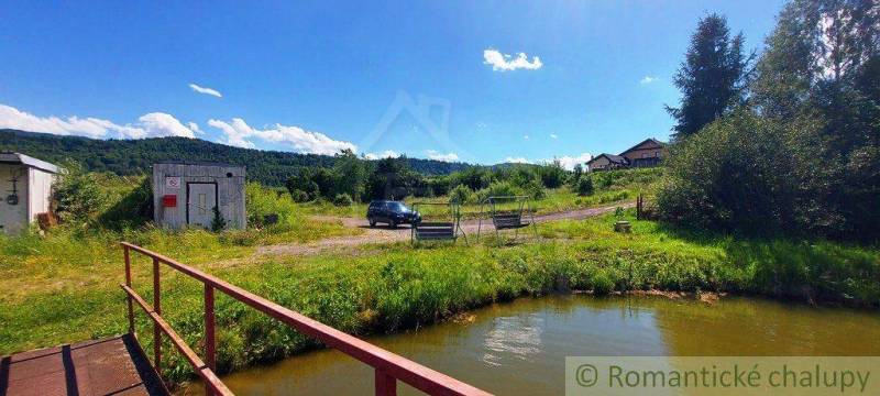Beautiful nature with a pond, a bridge, and recreational plots, ideal for relaxation.