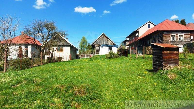 Country cottages on a green meadow, offering peace and unique properties.