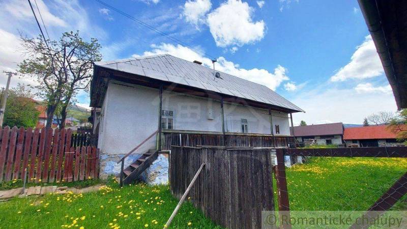 A historic house with a gabled roof and wooden fencing in a Special property.