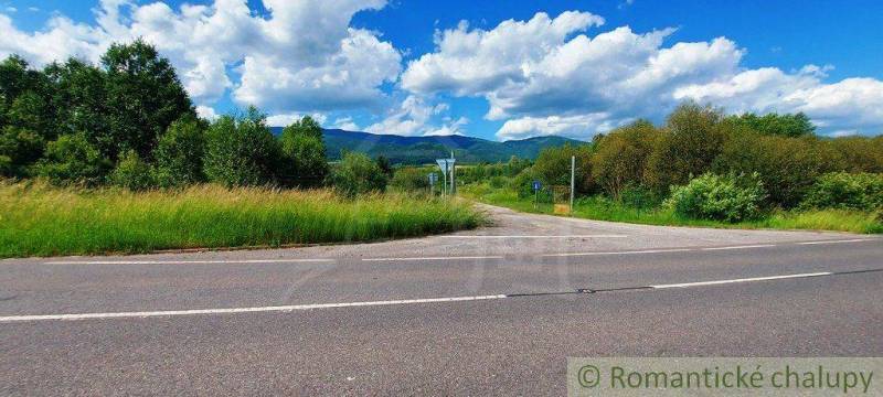 A road surrounded by green lands, suitable for living with a view of the mountains.