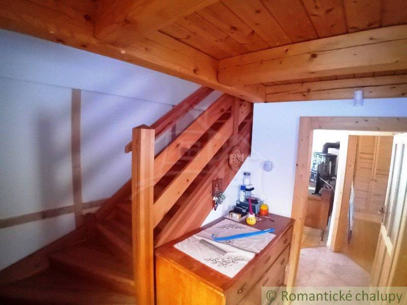 A wooden staircase in a cozy cottage with traditional furnishings, a touch of home.