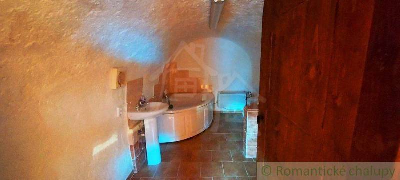 Underground bathroom with antique-style furnishings and unique vaulted ceilings. Unique properties.