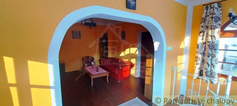 Living room with a vintage sofa and colorful walls, creating a unique property.