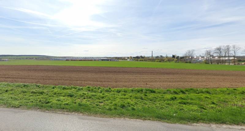 Vast fields and greenery in the background with urban buildings in Nitra suitable for commercial land.