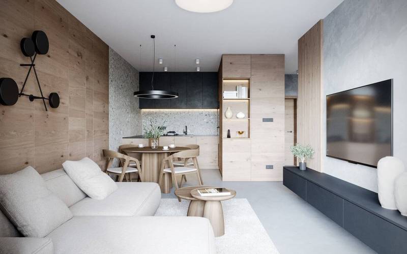 Bright interior of a holiday apartment with a comfortable sofa and a stylish dining table.