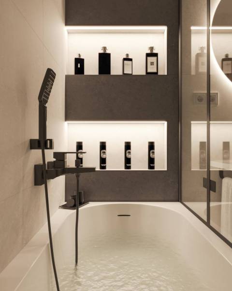 A bathroom in a holiday apartment with a filled bathtub and elegant lighting.