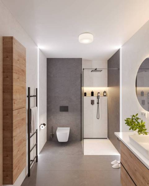 Bathroom in a holiday apartment with a modern shower and wooden storage furniture.