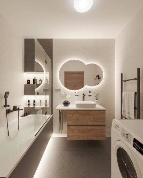 Bathroom in a holiday apartment with lights, cosmetics, and a mirror above the sink.
