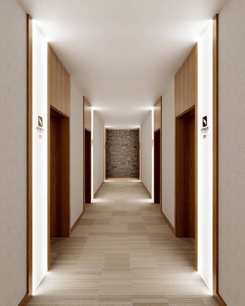 Hallway in a recreational apartment with modern lighting and wooden doors.