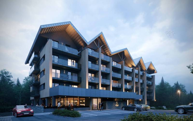 Štôla, a recreational apartment with modern architecture, glass balconies, and parking spaces.