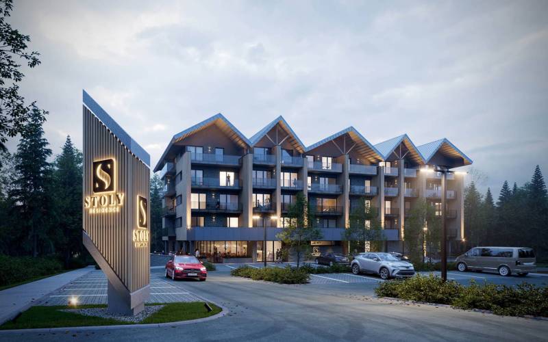 A recreational apartment in Štôla with modern architecture and an illuminated entrance in an evening setting.