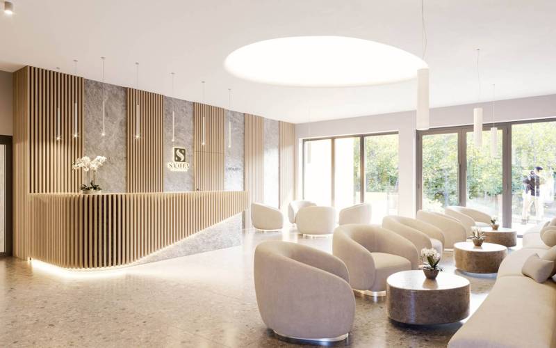 Stylish interior of a Holiday Apartment with modern white armchairs and a designer reception.