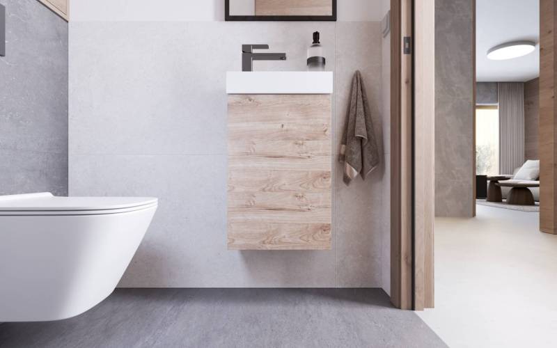 Bathroom in a holiday apartment with wooden furniture, a sink, and towels.