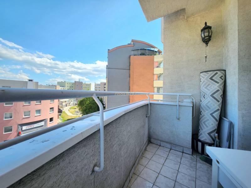 A balcony with tiles and a view of apartment buildings in Karlova Ves on Cikkerova Street.