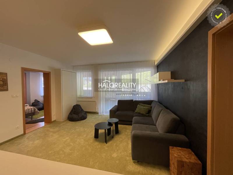 Living room in a 3-room apartment with a sofa, light walls, and a black accent.