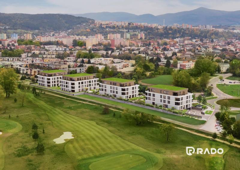 View from Karpatská Street in Trenčín of residential buildings with a golf course.