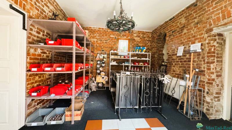 Brick walls of the room with shelves, metal products, and red boxes in the family house.